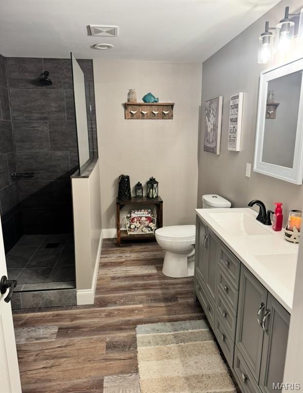 616 Remmick Stables Ct, Ofallon, MO 63368 - bathroom with wood finished floors, double vanity, and tiled shower