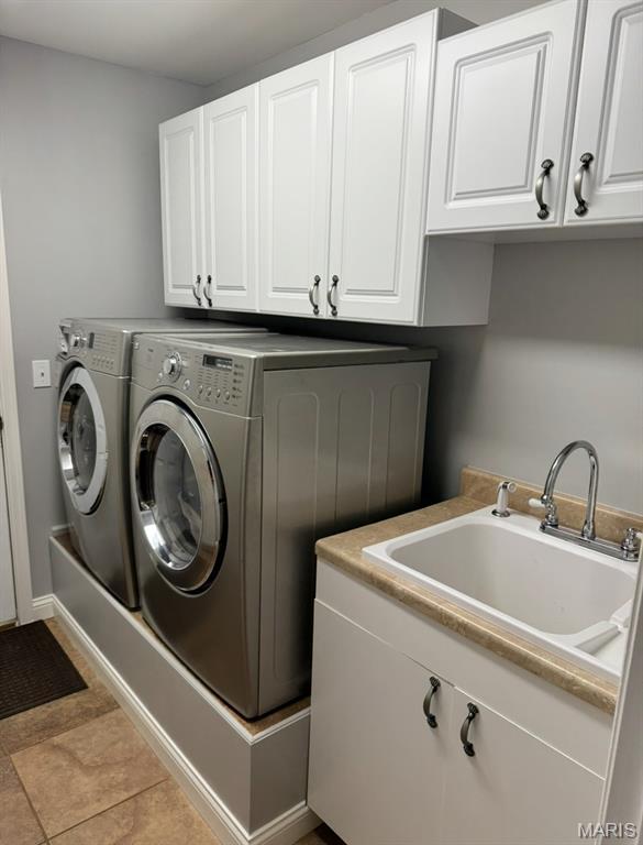 616 Remmick Stables Ct, Ofallon, MO 63368 - laundry area with cabinet space and washer and clothes dryer