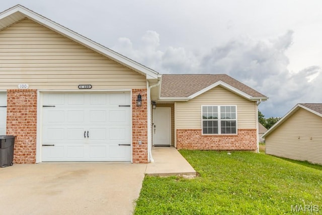 100 Edna St Unit B, Waynesville, MO 65583 - view of front of property featuring brick siding, concrete driveway, a front yard, an attached garage, and roof with shingles