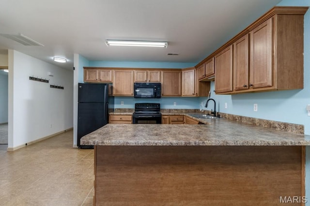 100 Edna St Unit B, Waynesville, MO 65583 - kitchen with black appliances, a peninsula, and brown cabinetry