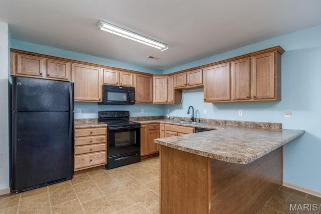 100 Edna St Unit B, Waynesville, MO 65583 - kitchen featuring black appliances, a peninsula, light countertops, and a breakfast bar area
