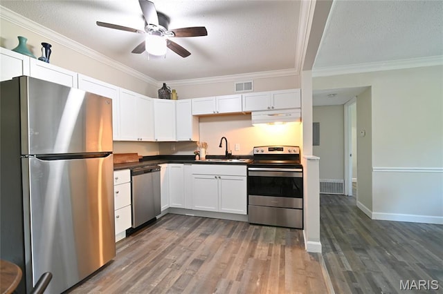 2745 Westphalia Ct Unit F, Oakville, MO 63129 - kitchen featuring stainless steel appliances, range hood, ceiling fan, dark countertops, and wood finished floors