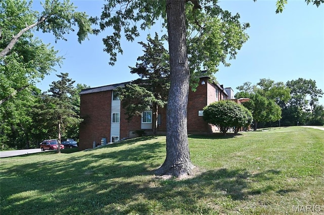 2745 Westphalia Ct Unit F, Oakville, MO 63129 - view of home's exterior featuring a lawn and brick siding