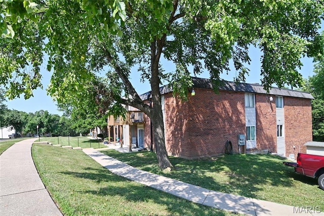 2745 Westphalia Ct Unit F, Oakville, MO 63129 - view of property exterior featuring a yard, brick siding, and a deck