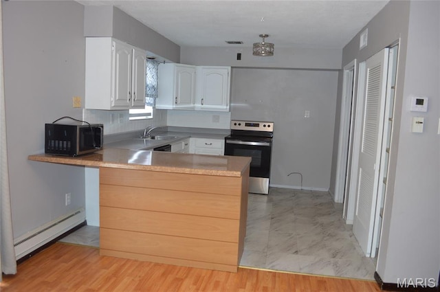 1726 Mayenne Ct, Saint Louis, MO 63125 - kitchen with stainless steel appliances, a baseboard heating unit, a peninsula, white cabinets, and backsplash