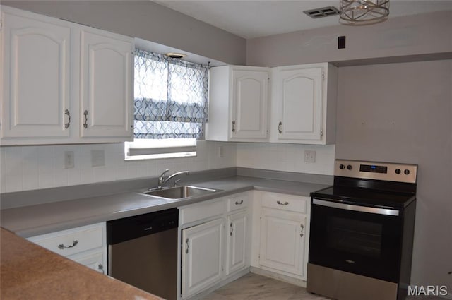 1726 Mayenne Ct, Saint Louis, MO 63125 - kitchen featuring appliances with stainless steel finishes, white cabinetry, and decorative backsplash