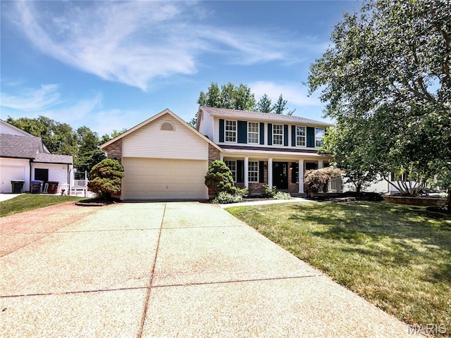 4033 Treeshadow Dr, Saint Peters, MO 63376 - view of front facade featuring an attached garage, a front lawn, concrete driveway, covered porch, and brick siding