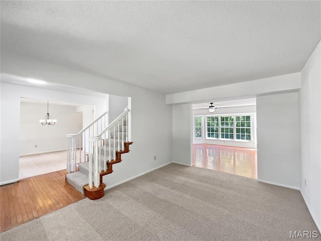 4033 Treeshadow Dr, Saint Peters, MO 63376 - unfurnished room with a chandelier, a textured ceiling, carpet, stairway, and ceiling fan