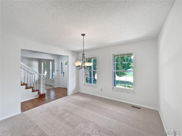 4033 Treeshadow Dr, Saint Peters, MO 63376 - carpeted empty room featuring a chandelier, stairs, and a textured ceiling