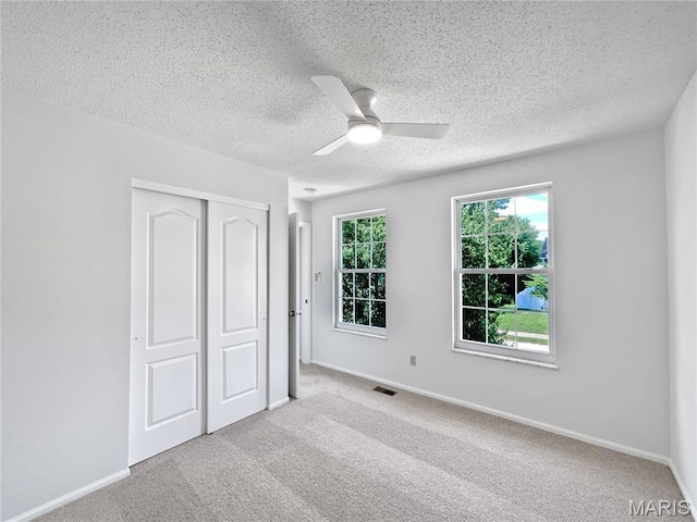 4033 Treeshadow Dr, Saint Peters, MO 63376 - unfurnished bedroom with a closet, a textured ceiling, carpet, and a ceiling fan
