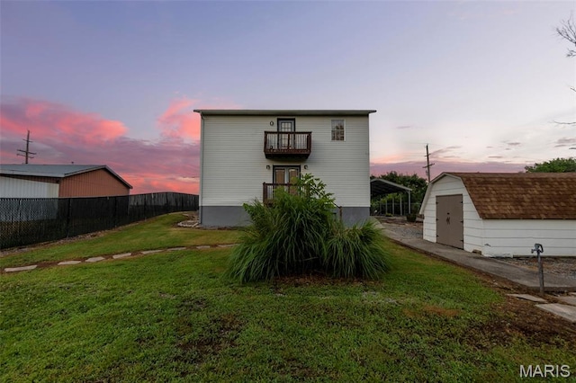 5748 State Highway 25, Cape Girardeau, MO 63701 - back of house at dusk with a balcony, a shed, and a carport