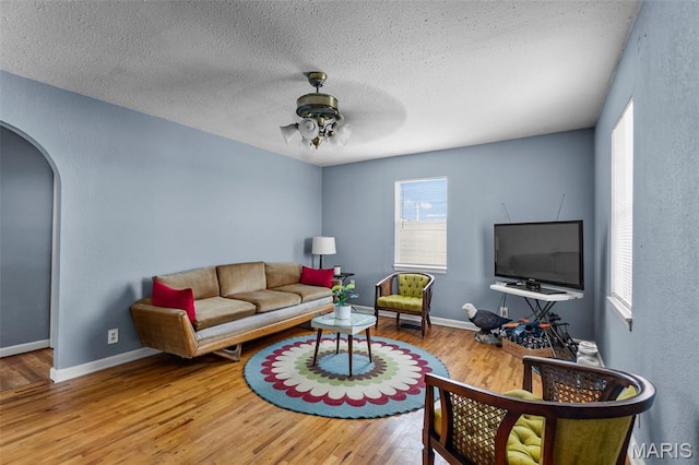 5748 State Highway 25, Cape Girardeau, MO 63701 - living room with arched walkways, wood finished floors, ceiling fan, and a textured ceiling