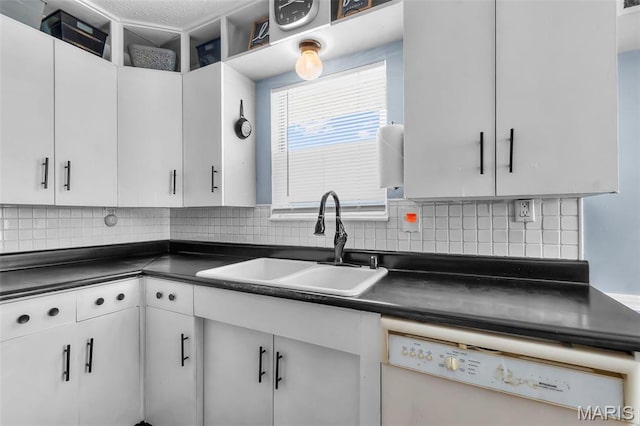 5748 State Highway 25, Cape Girardeau, MO 63701 - kitchen featuring white dishwasher, dark countertops, backsplash, and white cabinetry