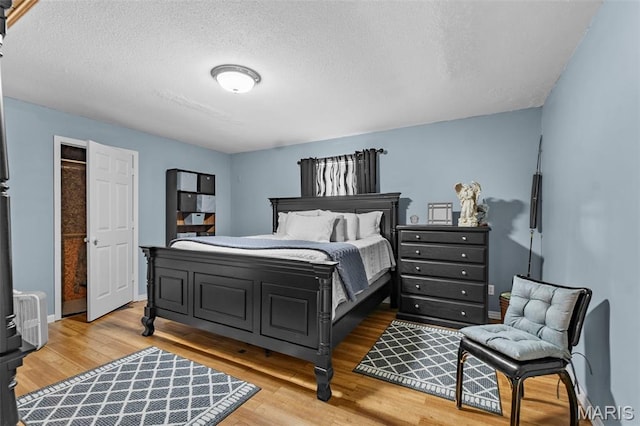 5748 State Highway 25, Cape Girardeau, MO 63701 - bedroom with light wood-style floors and a textured ceiling