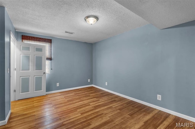5748 State Highway 25, Cape Girardeau, MO 63701 - empty room featuring wood finished floors and a textured ceiling