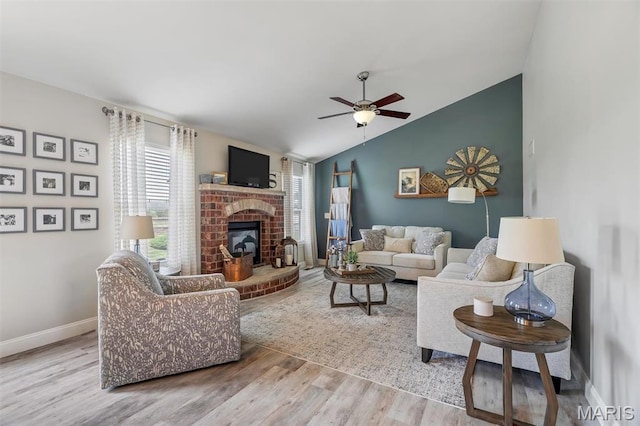 1209 Riesling Ln, Pevely, MO 63070 - living area with wood finished floors, vaulted ceiling, a ceiling fan, and a brick fireplace