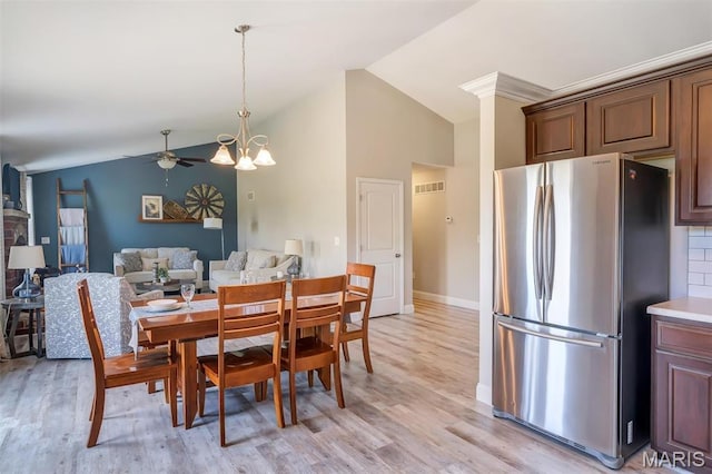 1209 Riesling Ln, Pevely, MO 63070 - dining area featuring ceiling fan, light wood-type flooring, a chandelier, and high vaulted ceiling