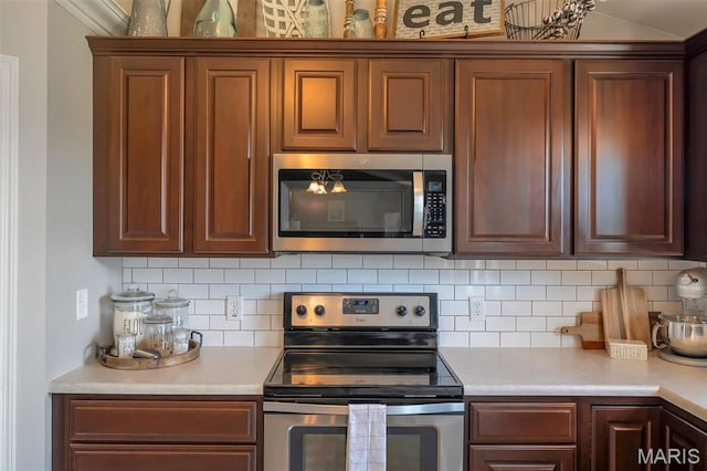 1209 Riesling Ln, Pevely, MO 63070 - kitchen featuring appliances with stainless steel finishes, light countertops, and backsplash