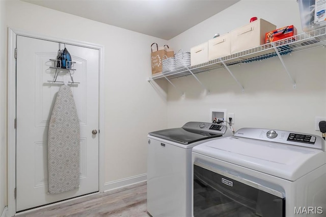 1209 Riesling Ln, Pevely, MO 63070 - laundry room featuring washer and clothes dryer, light wood finished floors, and a desk