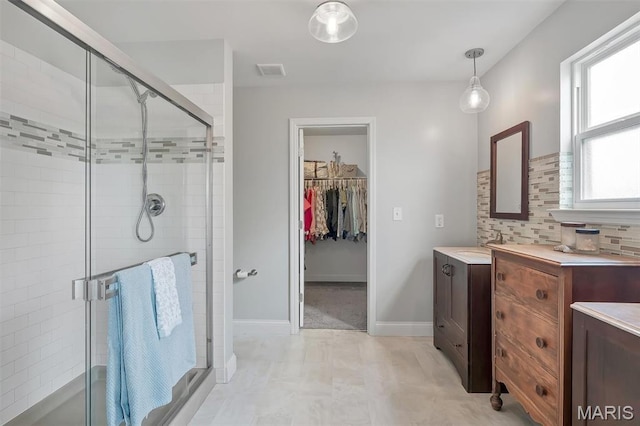 1209 Riesling Ln, Pevely, MO 63070 - bathroom featuring a shower stall, vanity, a spacious closet, and backsplash