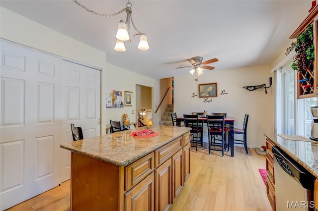 6 Barkwood Ct, Saint Peters, MO 63376 - kitchen with dishwasher, brown cabinetry, light stone countertops, ceiling fan, and light wood-style floors