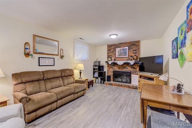 6 Barkwood Ct, Saint Peters, MO 63376 - living room featuring light wood-style floors and a brick fireplace