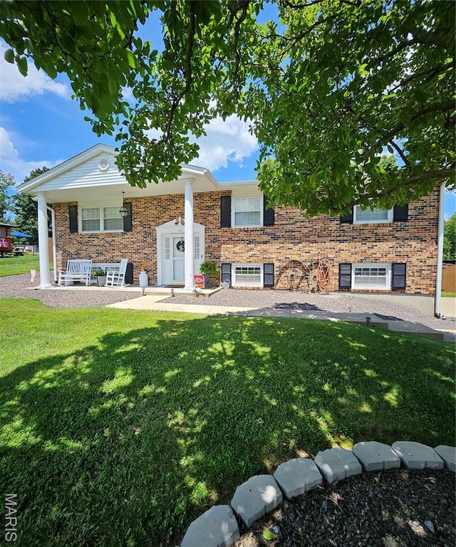22 Settlers Trl, Hannibal, MO 63401 - raised ranch featuring covered porch, a front lawn, and brick siding
