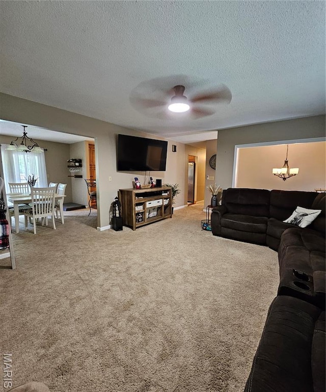 22 Settlers Trl, Hannibal, MO 63401 - carpeted living room featuring a chandelier, a ceiling fan, and a textured ceiling