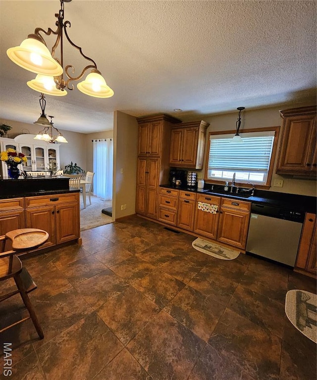 22 Settlers Trl, Hannibal, MO 63401 - kitchen featuring stainless steel dishwasher, dark countertops, brown cabinets, a textured ceiling, and pendant lighting