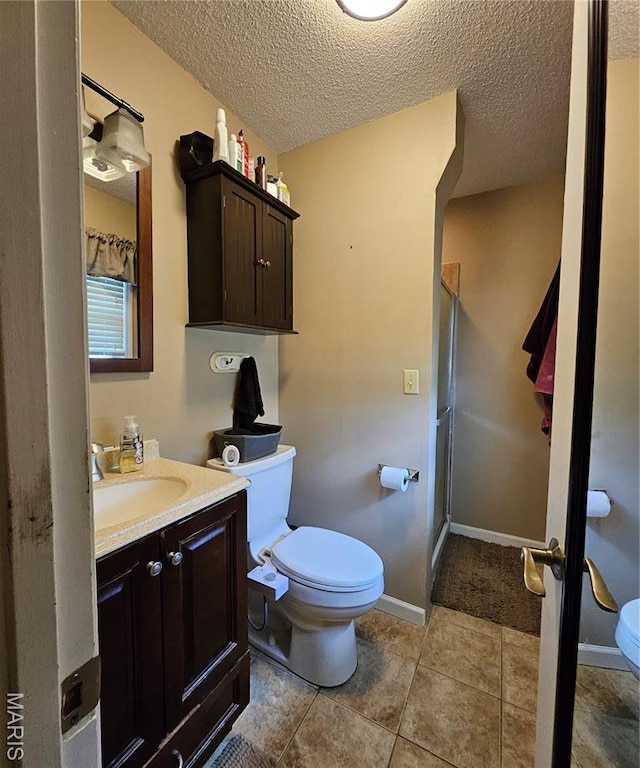22 Settlers Trl, Hannibal, MO 63401 - bathroom with vanity, a shower stall, a textured ceiling, and tile patterned floors