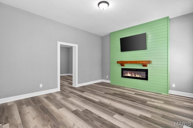 207 N 13th St, Belleville, IL 62220 - unfurnished living room with wood finished floors and a large fireplace