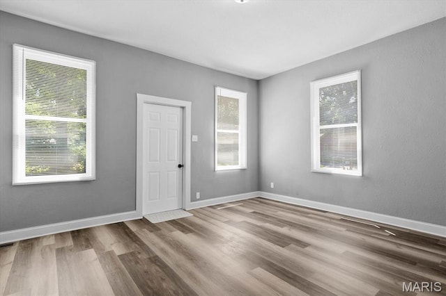 207 N 13th St, Belleville, IL 62220 - empty room featuring wood finished floors and baseboards