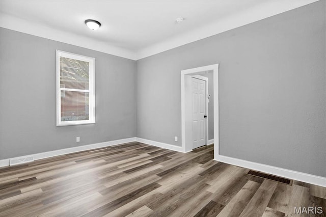 207 N 13th St, Belleville, IL 62220 - spare room featuring wood finished floors and baseboards