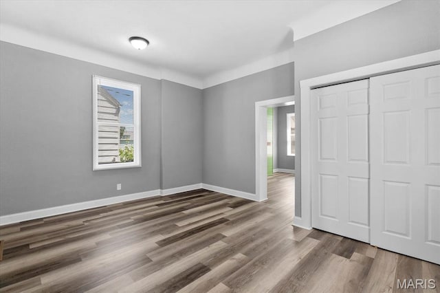 207 N 13th St, Belleville, IL 62220 - unfurnished bedroom with wood finished floors and a closet