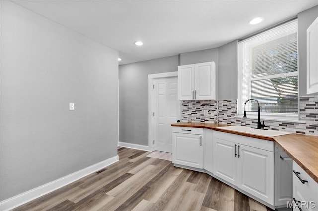207 N 13th St, Belleville, IL 62220 - kitchen with wooden counters, white cabinetry, tasteful backsplash, light wood-style floors, and recessed lighting