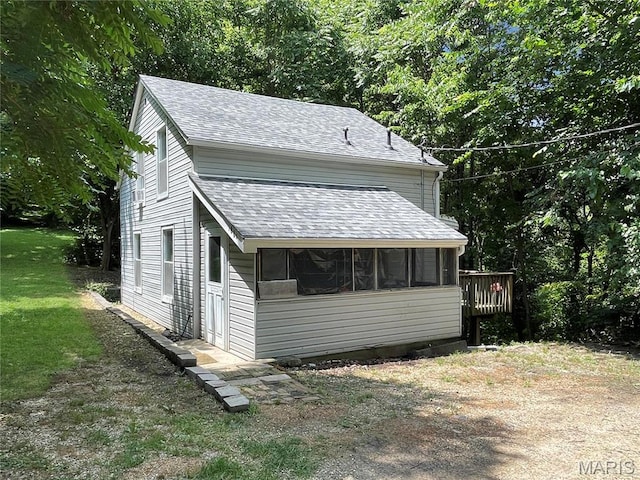 100A Wall St, New Haven, MO 63068 - view of property exterior with roof with shingles, a sunroom, and a yard