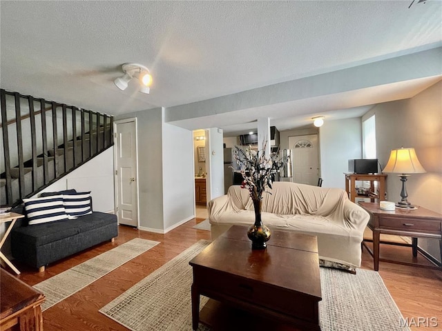 100A Wall St, New Haven, MO 63068 - living room with stairs, wood finished floors, and a textured ceiling