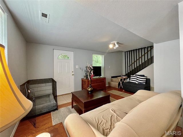 100A Wall St, New Haven, MO 63068 - living room featuring wood finished floors, stairway, and a textured ceiling