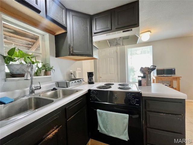 100A Wall St, New Haven, MO 63068 - kitchen featuring black / electric stove, under cabinet range hood, stainless steel microwave, a peninsula, and light countertops