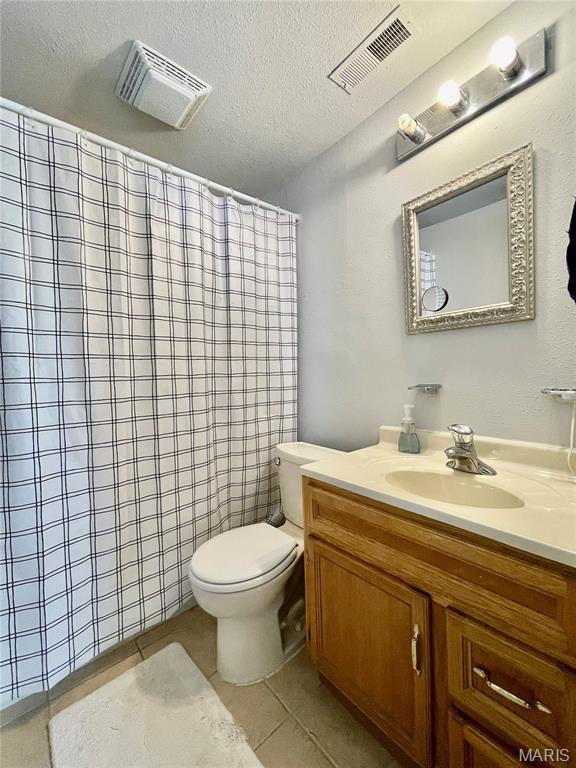 100A Wall St, New Haven, MO 63068 - bathroom featuring vanity, tile patterned floors, curtained shower, and a textured ceiling