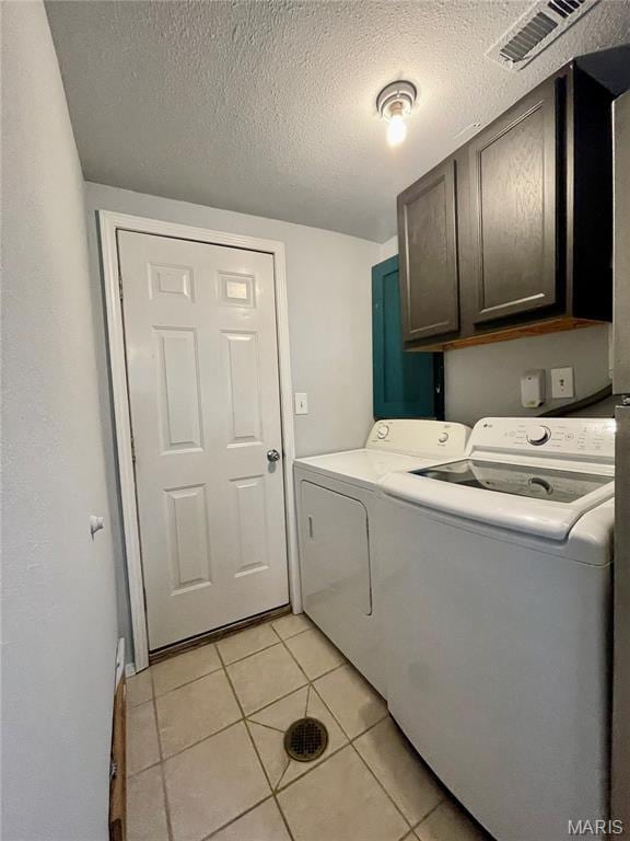 100A Wall St, New Haven, MO 63068 - laundry area featuring cabinet space, separate washer and dryer, light tile patterned flooring, and a textured ceiling