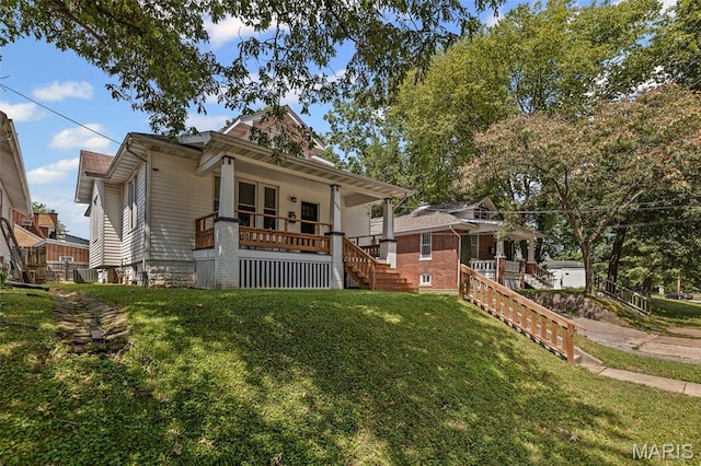 505 Sycamore St, Belleville, IL 62220 - bungalow featuring a porch, a front lawn, and stairs