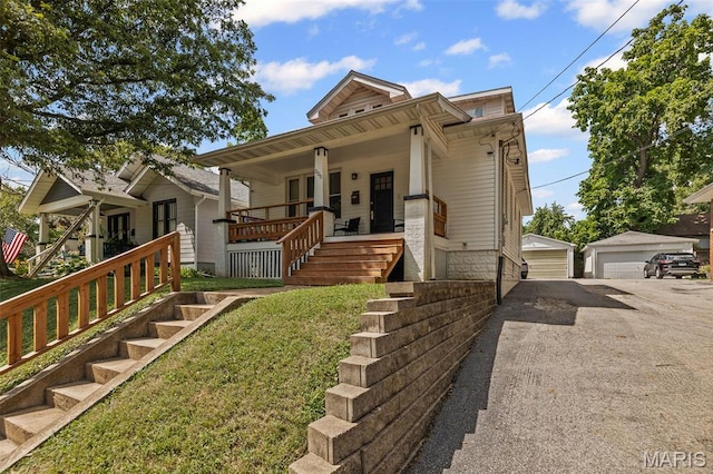 505 Sycamore St, Belleville, IL 62220 - bungalow-style home with covered porch, a detached garage, an outbuilding, stairway, and a front yard