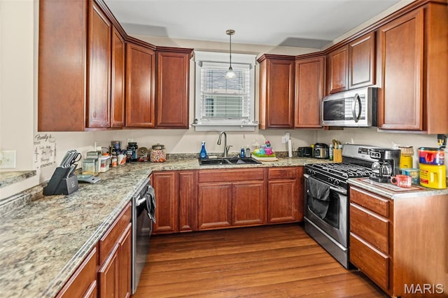 505 Sycamore St, Belleville, IL 62220 - kitchen with stainless steel appliances, dark wood finished floors, light stone counters, pendant lighting, and brown cabinets