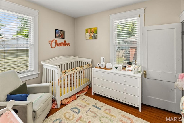 505 Sycamore St, Belleville, IL 62220 - bedroom featuring a nursery area and dark wood-style floors