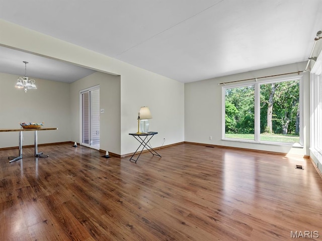 4488 Rock Creek Valley Rd, House Springs, MO 63051 - unfurnished room featuring a chandelier and wood finished floors