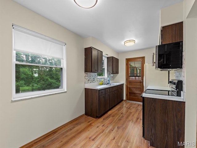 4488 Rock Creek Valley Rd, House Springs, MO 63051 - kitchen featuring light countertops, plenty of natural light, stove, and decorative backsplash
