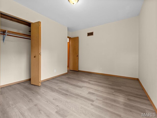 4488 Rock Creek Valley Rd, House Springs, MO 63051 - unfurnished bedroom with light wood-type flooring and a closet