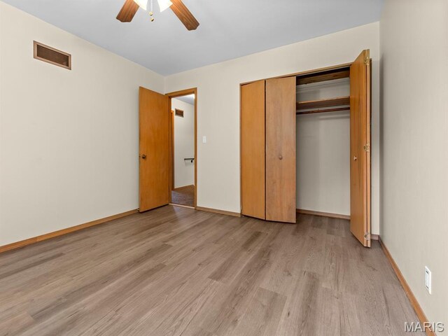 4488 Rock Creek Valley Rd, House Springs, MO 63051 - unfurnished bedroom with light wood finished floors, a closet, and a ceiling fan