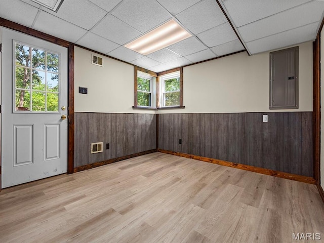 4488 Rock Creek Valley Rd, House Springs, MO 63051 - spare room with a paneled ceiling, light wood-type flooring, electric panel, and a wainscoted wall